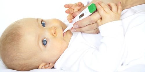 baby with a thermometer in his mouth