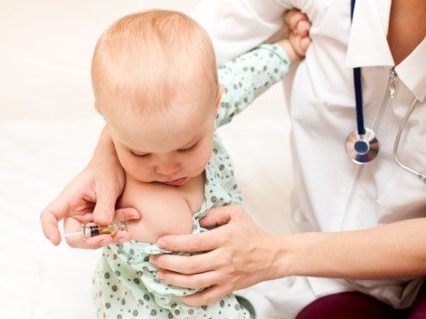 Small child in the arms of a doctor