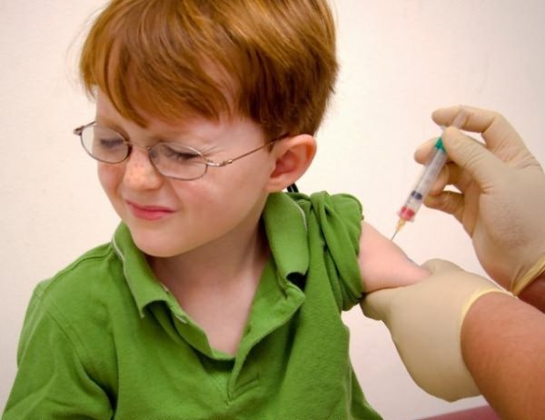 Red-haired boy is afraid of vaccination