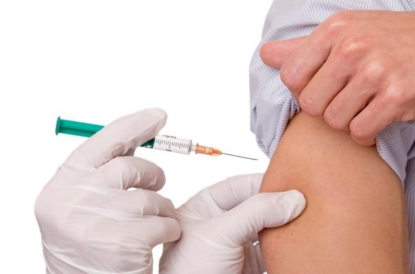 Injection with a syringe in the arm